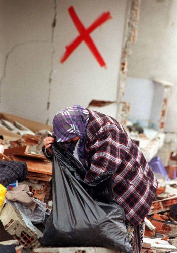 Deprem sonrası Kaynaşlı'da yaşayan vatandaşlar yıkılan binalardan eşyalarını toplarken görülüyor.
